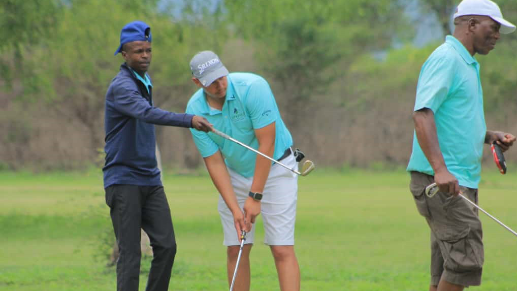 Luphohlo Managing Director, National Van Zuydam (c) readying himself to put the ball on the green, while team member, Machawe Maziya gives him pointers. (Pics: Melusi Mkhabela)